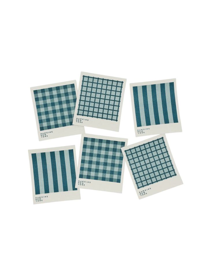 Six sponge cloths featuring assorted blue plaid, striped, and windowpane patterns are arranged against a black background to showcase the complete Essential Swedish Dishcloth in Sky/Peacock (Set of 6) from Hawkins New York | Twentyseven Toronto