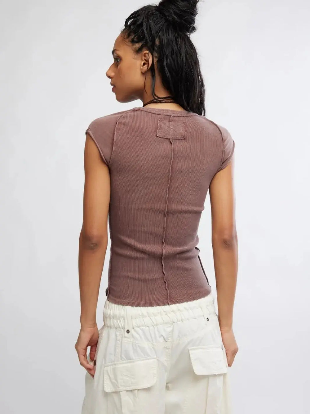 A rear studio shot emphasizes the exposed center back seam and topstitched square accent on the Free People Ever Had Tee in Brunette | Twentyseven Toronto