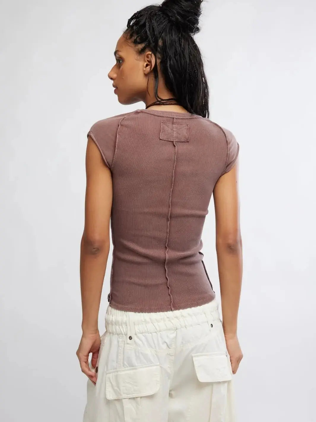 A rear studio shot emphasizes the exposed center back seam and topstitched square accent on the Free People Ever Had Tee in Brunette | Twentyseven Toronto