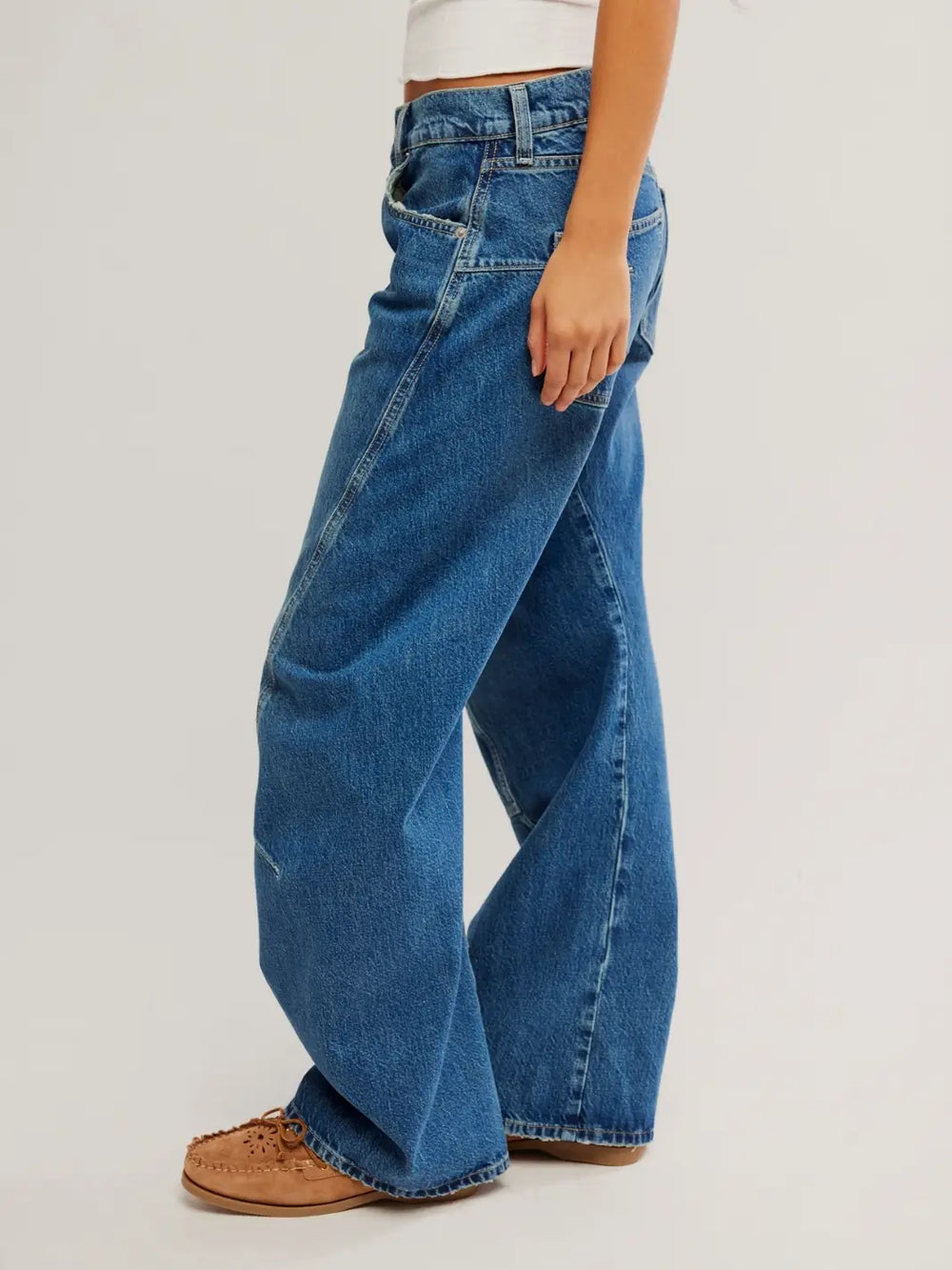 A side profile view captures the distinct forward-curving side seam and relaxed silhouette of the Free People Fable Twisted Seam Jean in Heartsong | Twentyseven Toronto