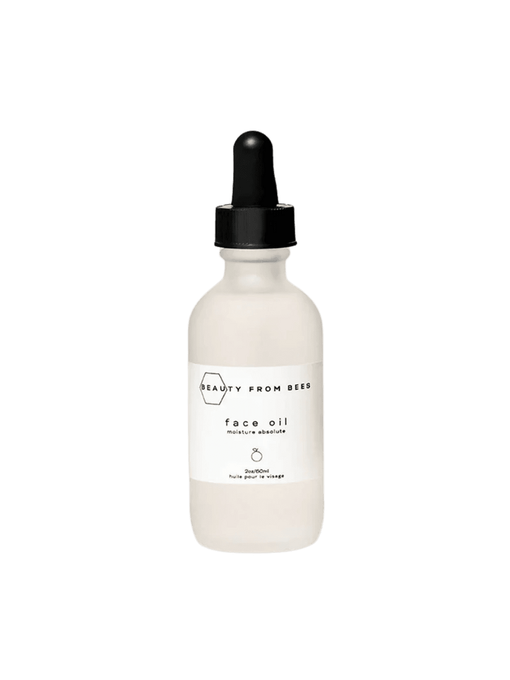 White face oil bottle from Beauty from Bees with black dropper on a transparent background | Twentyseven Toronto