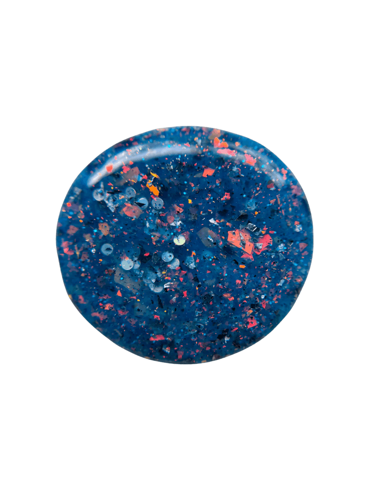 Circular dollop color swatch of Death Valley Nails Fish Scales Nail Polish, showing its deep teal-blue base packed with vibrant orange, gold, and blue reflective flakies | Twentyseven Toronto