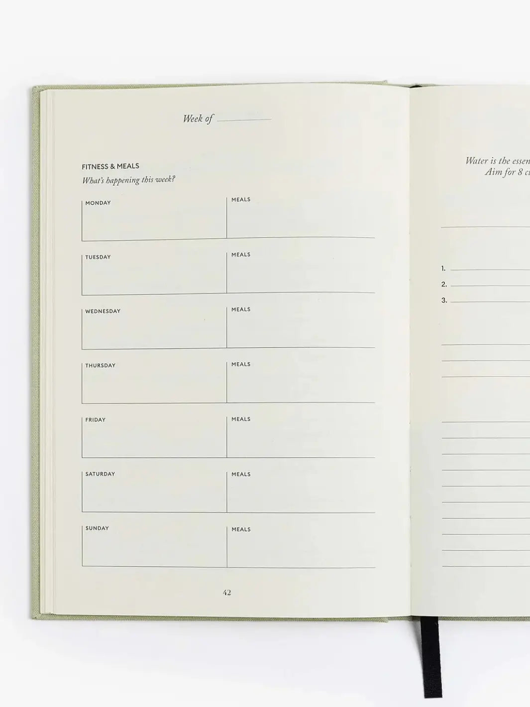 The weekly fitness and meals schedule page sits completely blank inside the open Intelligent Change The Five Minute Journal Health & Fitness Edition | Twentyseven Toronto