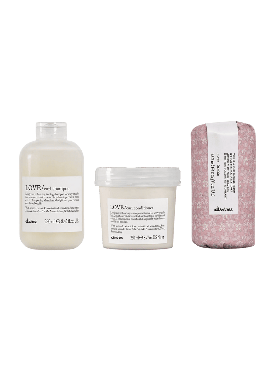 Davines hair care products including LOVE Curl Shampoo (250ml), LOVE Curl Conditioner (250ml), and This is A Curl Building Serum (250ml) on a transparent background | Twentyseven Toronto