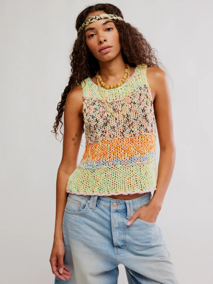 Woman wearing a colorful 'Flea Market Knot Tank' sleeveless top in 'Paradise Combo' and denim shorts on a white background | Twentyseven Toronto