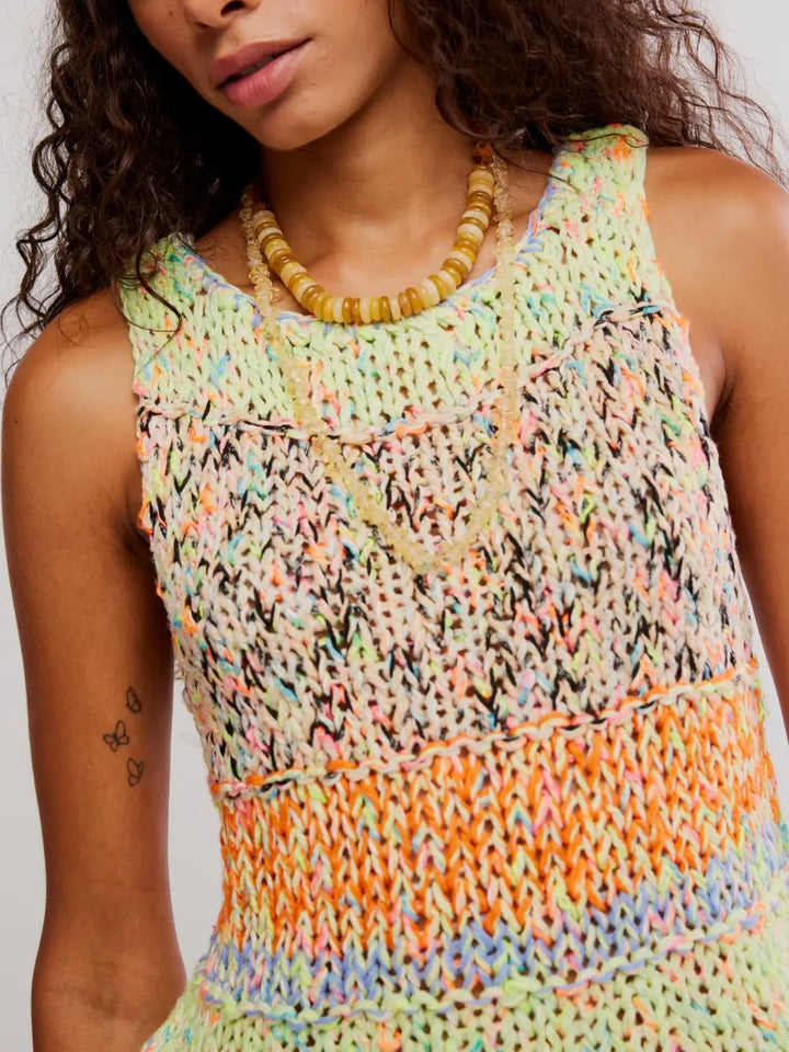 Close up of woman wearing a colorful 'Flea Market Knot Tank' sleeveless top in 'Paradise Combo' from Free People on a white background | Twentyseven Toronto