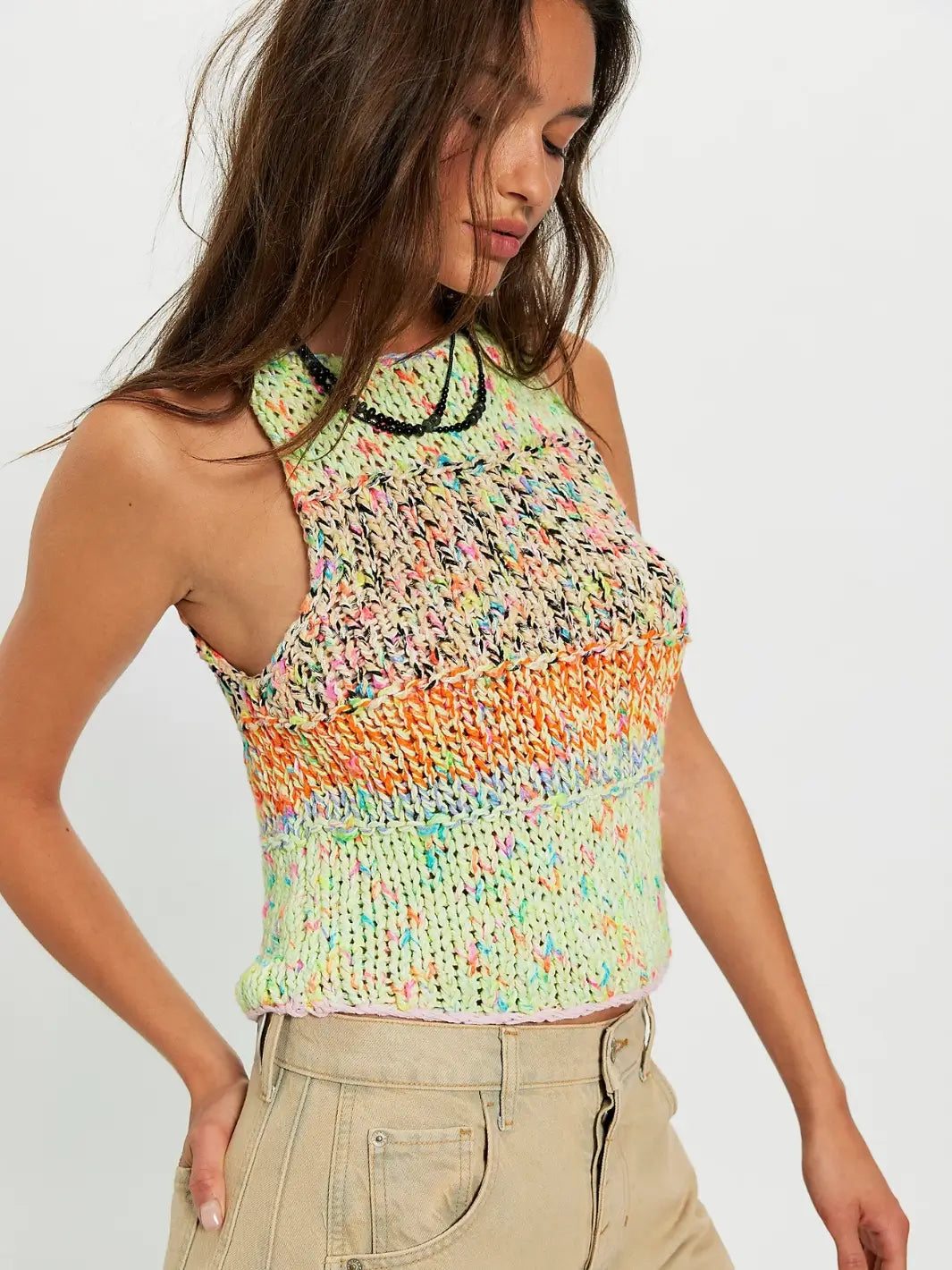 Woman wearing a colorful 'Flea Market Knot Tank' sleeveless top in 'Paradise Combo' from Free People on a white background | Twentyseven Toronto