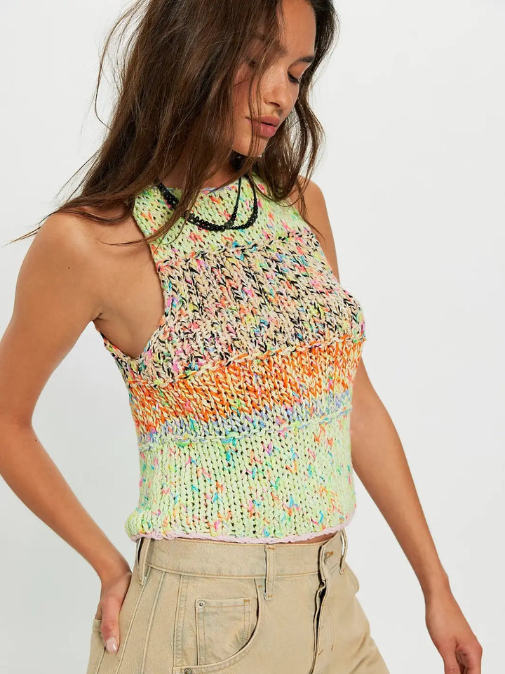 Woman wearing a colorful 'Flea Market Knot Tank' sleeveless top in 'Paradise Combo' from Free People on a white background | Twentyseven Toronto