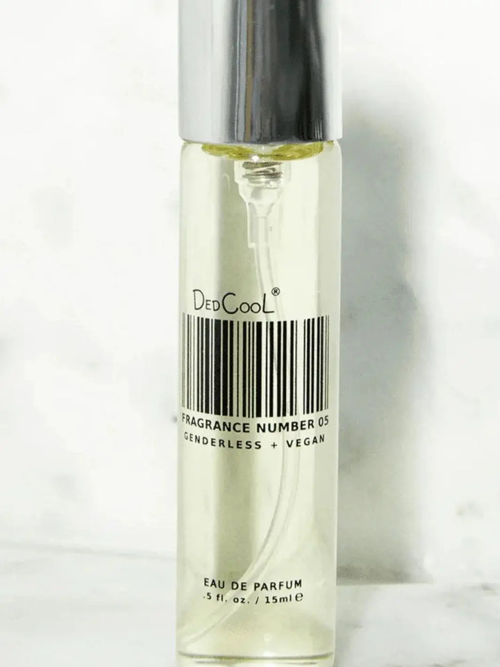 A slim, 15ml travel-size spray bottle of Dedcool Fragrance 05 "Spring" stands upright against a light textured backdrop | Twentyseven Toronto