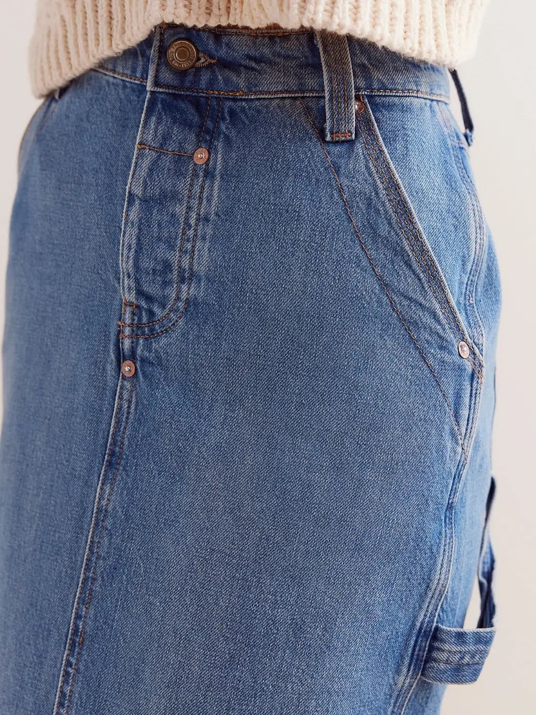 A close-up shot highlights the front pocket design, contrast stitching, copper rivets, and side utility loop of the Free People We The Free Francisco Denim Maxi Skirt - Head Over Heels | Twentyseven Toronto