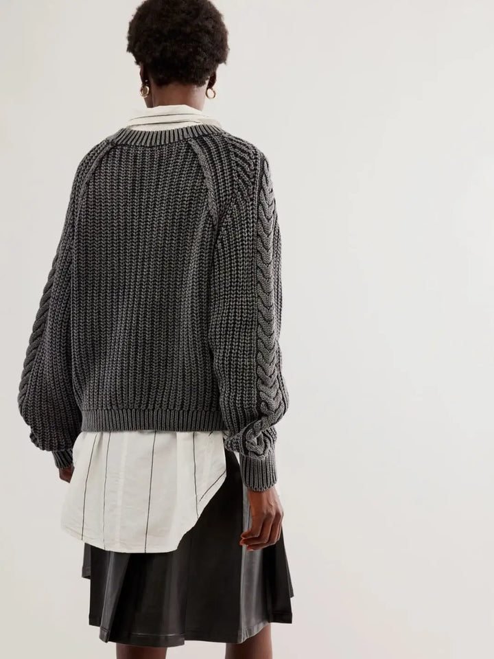 A full rear view shows the drop-tail layering style, voluminous sleeves, and textured back construction of the Free People Frankie Cable Sweater in Black | Twentyseven Toronto
