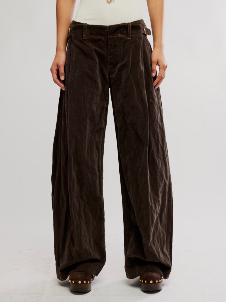 Front view of the Free People Holding Onto This Trouser in brown with a relaxed wide-leg silhouette and pleated waist | Twentyseven Toronto
