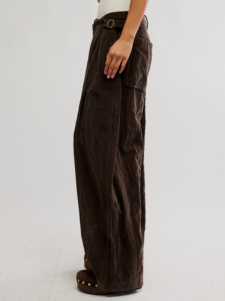 Side view of the Free People Holding Onto This Trouser in brown with wide legs and adjustable buckle detail at the waist | Twentyseven Toronto