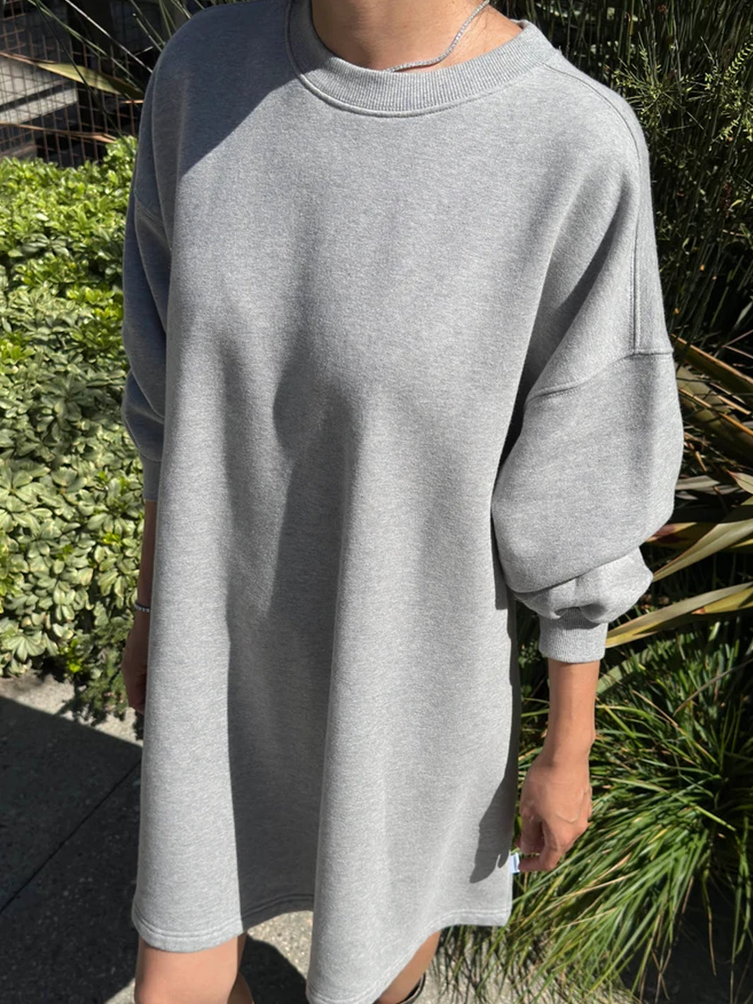 Le Bon Shoppe French Terry Swing Dress in Grey Melange worn outdoors, showing balloon sleeve and relaxed fit | Twentyseven Toronto