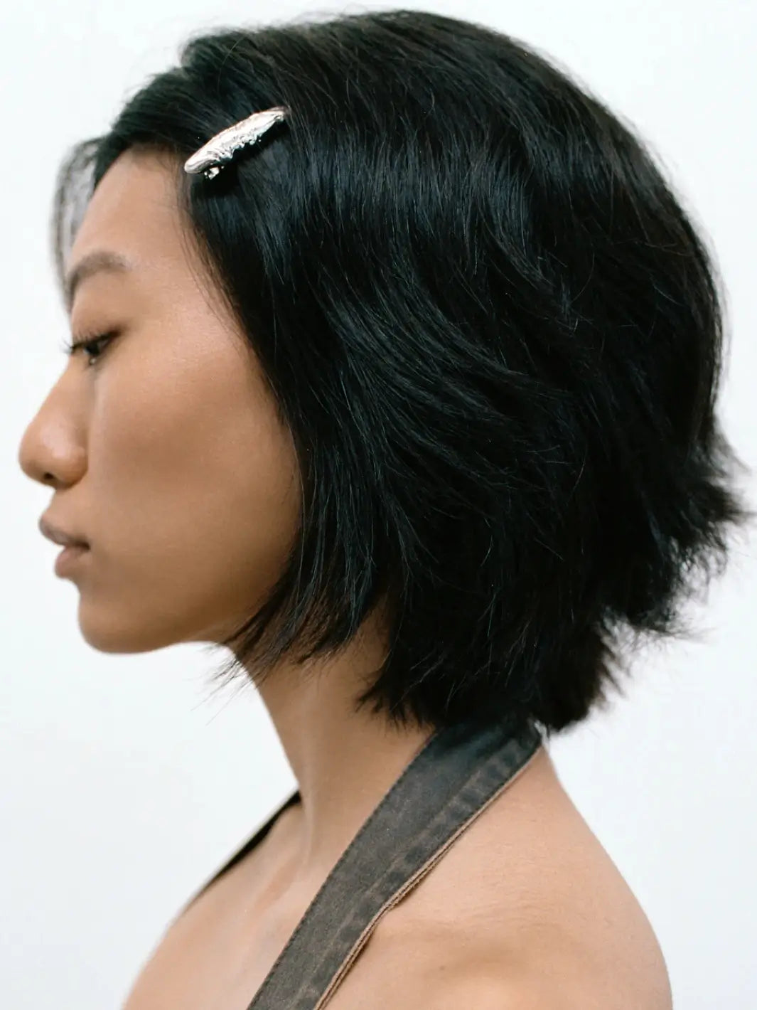 A woman with dark short hair wearing a silver textured Frida Clip in Silver from Wolf Circus | Twentyseven Toronto