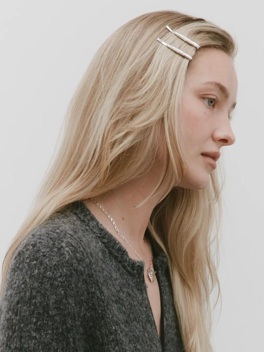 Woman with blonde hair wears two molten-textured Frida Pins in Silver from Wolf Circus | Twentyseven Toronto