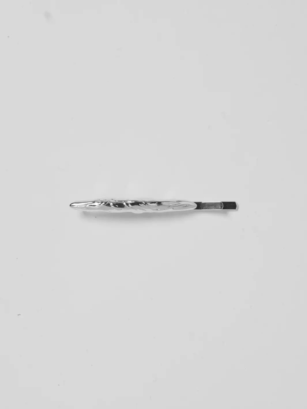 A single, molten-textured Frida Pins in Silver from Wolf Circus centered against a white background | Twentyseven Toronto