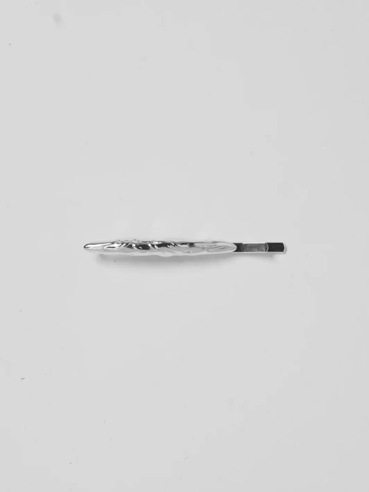 A single, molten-textured Frida Pins in Silver from Wolf Circus centered against a white background | Twentyseven Toronto