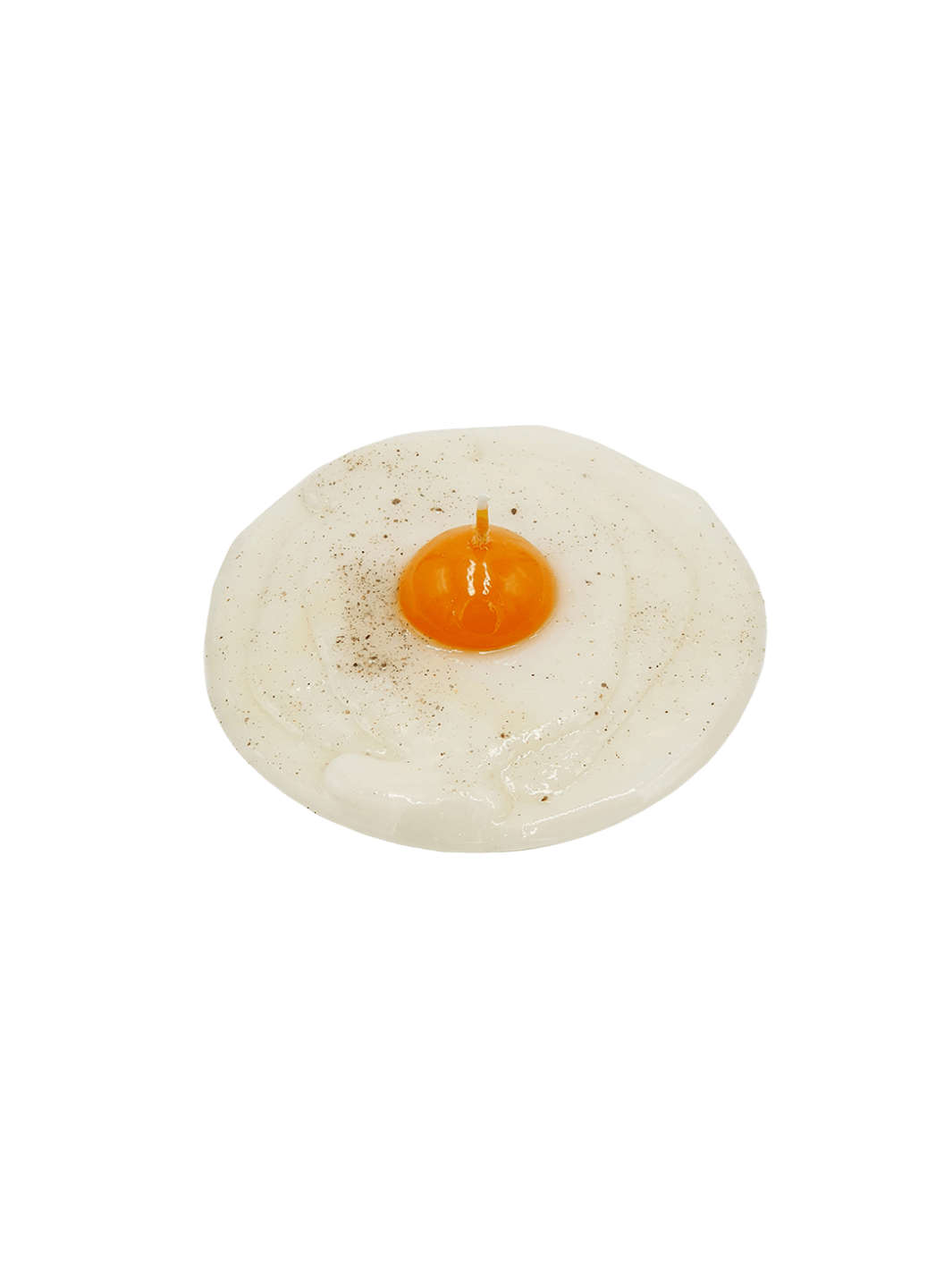 Fried egg shaped candle with pepper details from Cereria Introna on a transparent background | Twentyseven Toronto