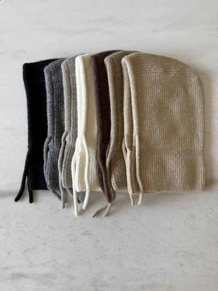 Six Billy Bamboo Fuzzy Alpaca Balaclava hoods are stacked sideways to showcase a neutral color gradient from black, grey, and off-white to brown, taupe, and beige | Twentyseven Toronto