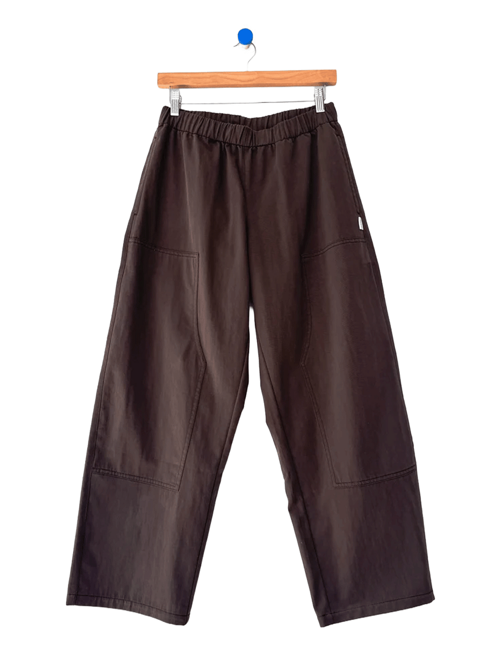 Le Bon Shoppe Gardener’s Pants in Espresso shown on a hanger, featuring a wide-leg silhouette, elastic waistband and oversized patch pockets | Twentyseven Toronto