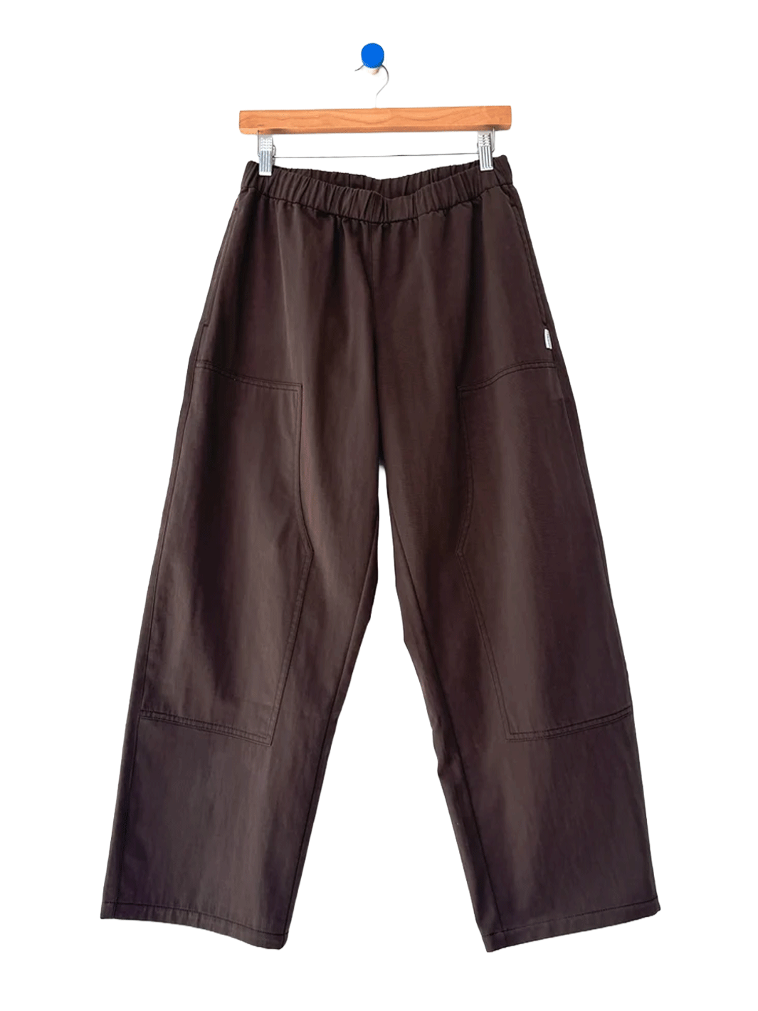 Le Bon Shoppe Gardener’s Pants in Espresso shown on a hanger, featuring a wide-leg silhouette, elastic waistband and oversized patch pockets | Twentyseven Toronto