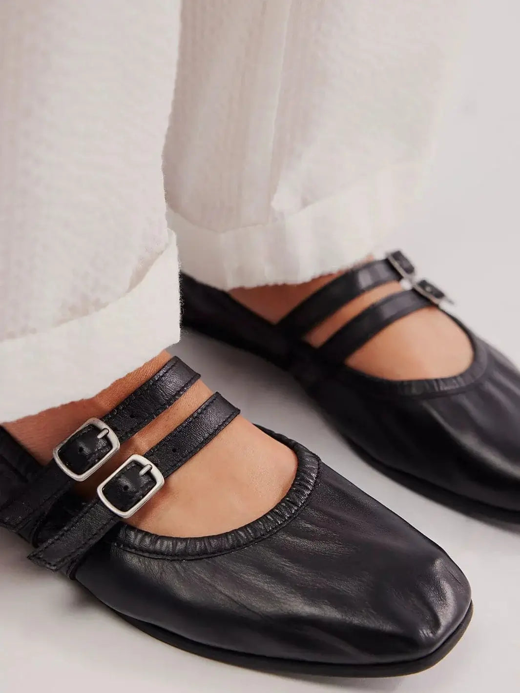 A close-up shot highlights the double adjustable buckle straps and gathered elastic detailing of the Free People Gemini Ballet Flats - Black | Twentyseven Toronto