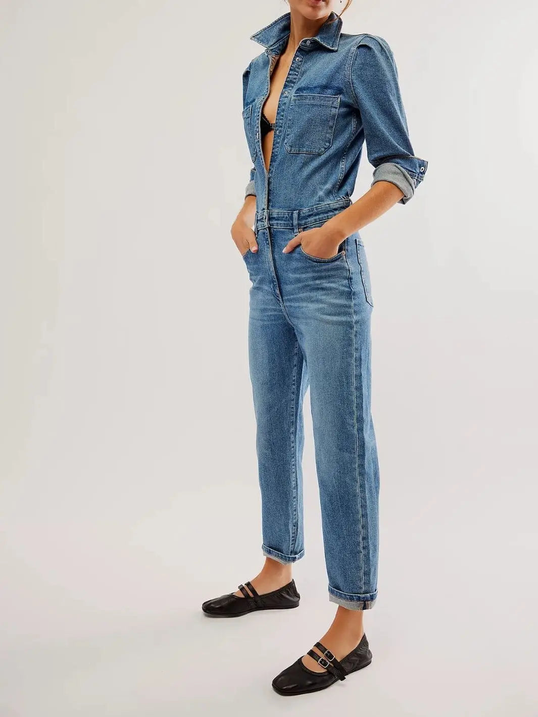 A full-length shot shows a model standing with hands in her pockets, wearing a blue denim jumpsuit styled with Free People Gemini Ballet Flats - Black | Twentyseven Toronto