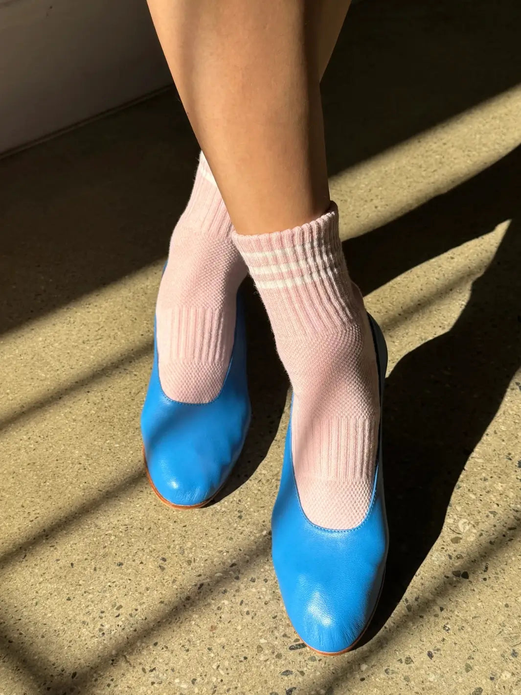 A person pairs the soft pink Le Bon Shoppe Girlfriend Sock in Peony with bright blue leather ballet flats | Twentyseven