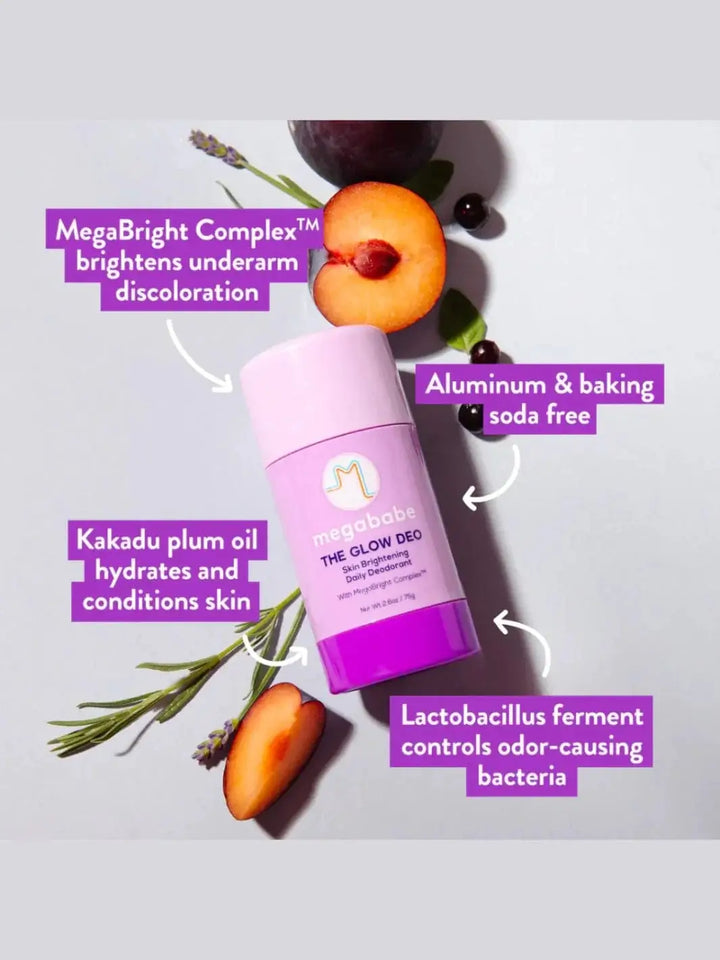 A purple stick of Megababe The Glow Deo is surrounded by sliced plums, lavender sprigs, and informative text detailing the product's skin-brightening ingredients and benefits | Twentyseven Toronto