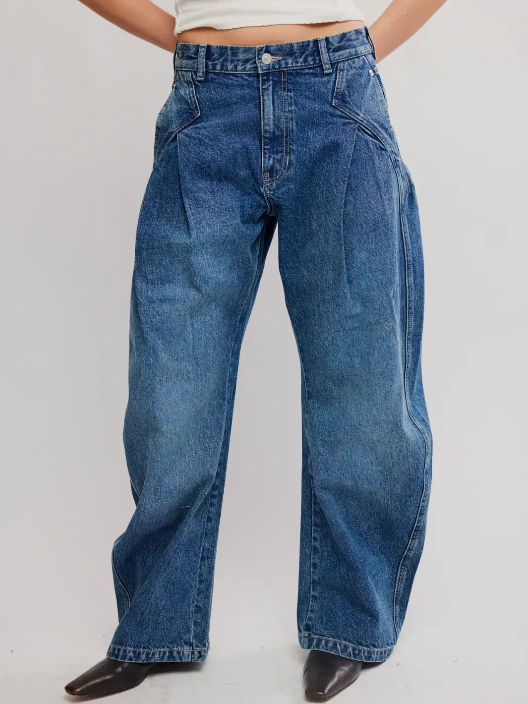 Front view of a model wearing wide-leg Free People We the Free Golden Hour Trouser Jeans in Deacon Blue paired with black boots | Twentyseven