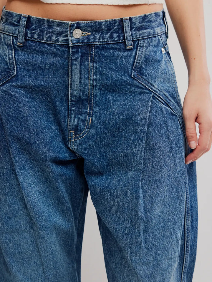 Close-up of the front waistband, pleats, and dark wash texture of the Free People We the Free Golden Hour Trouser Jeans in Deacon Blue | Twentyseven