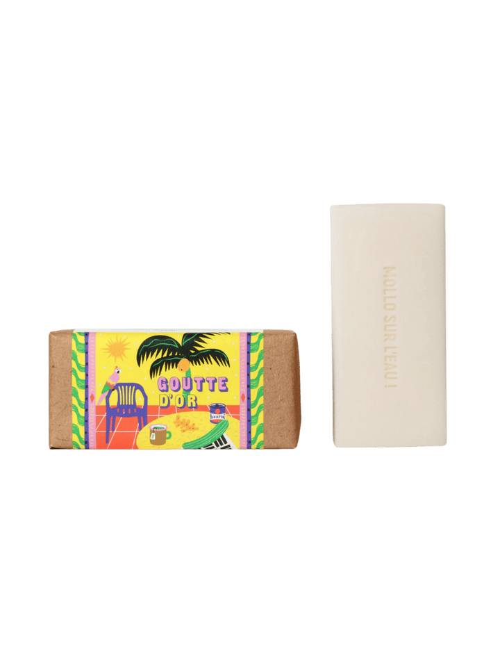 Maison Matine Goutte d'Or Bar Soap in colourful packaging with a bright yellow palm tree design next to bar soap 100g | Twentyseven Toronto