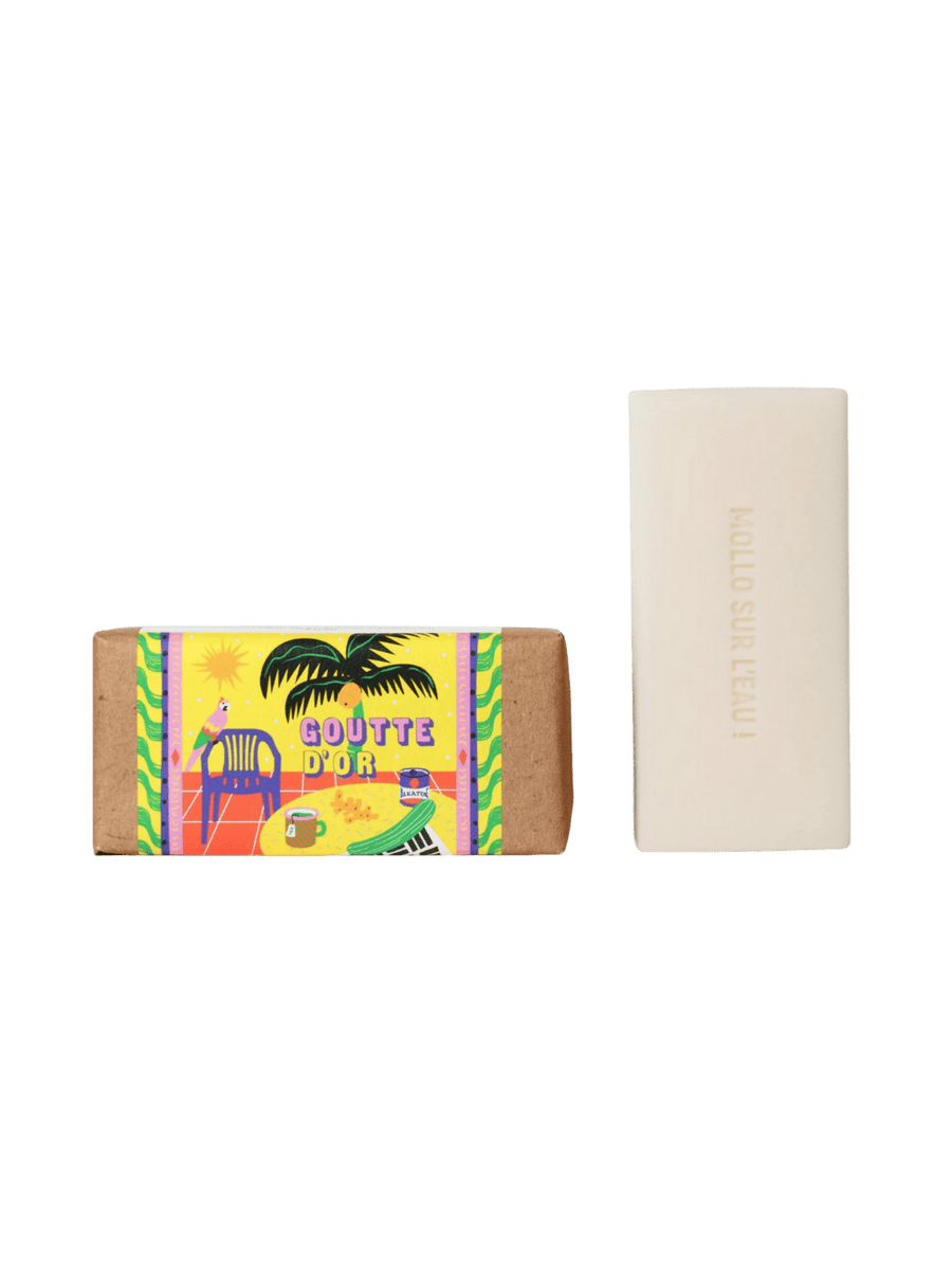 Maison Matine Goutte d'Or Bar Soap in colourful packaging with a bright yellow palm tree design next to bar soap 100g | Twentyseven Toronto