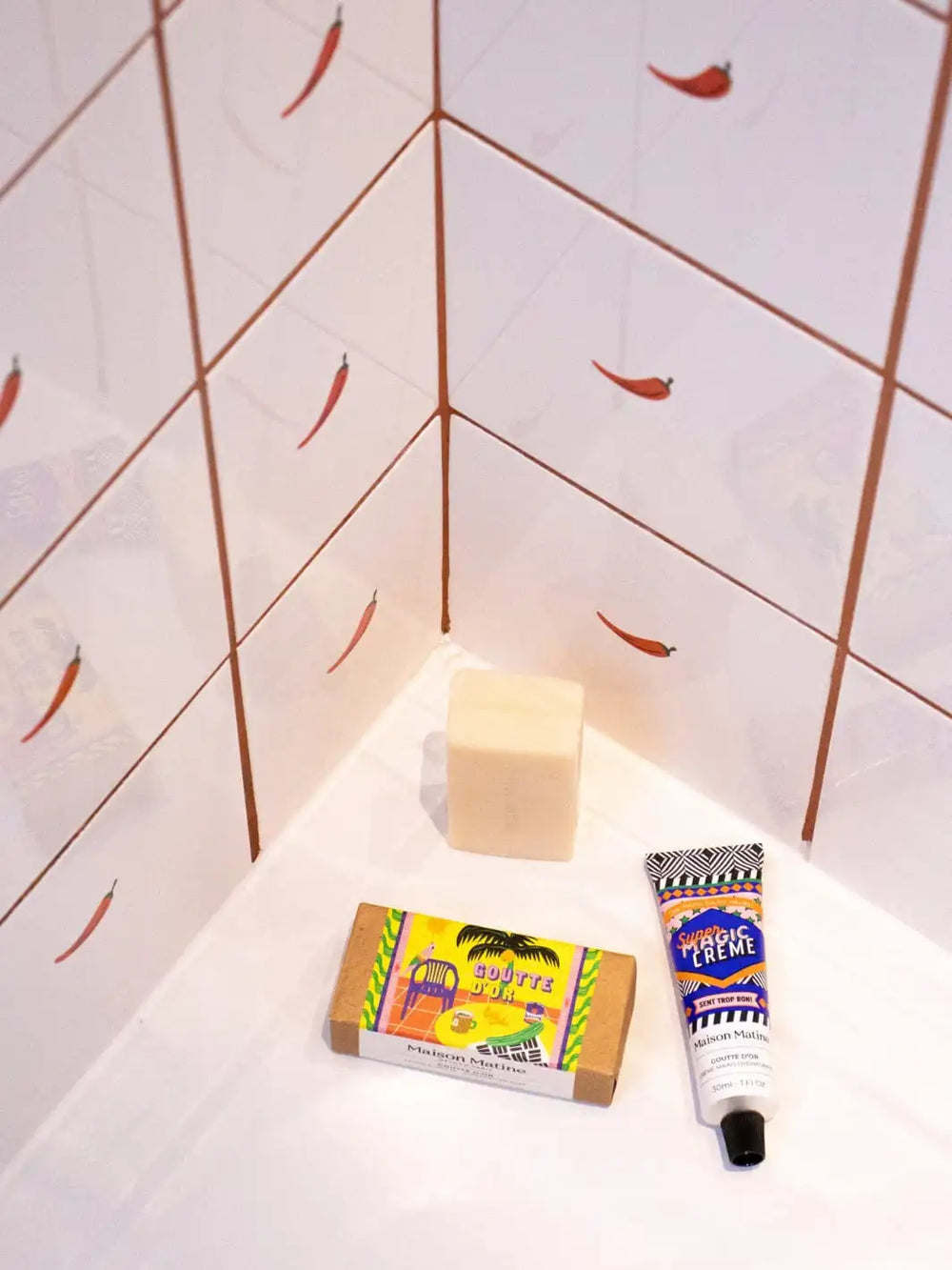 Maison Matine Goutte d'Or Bar Soap and tube of hand cream on a white surface with tiled wall background 100g | Twentyseven Toronto