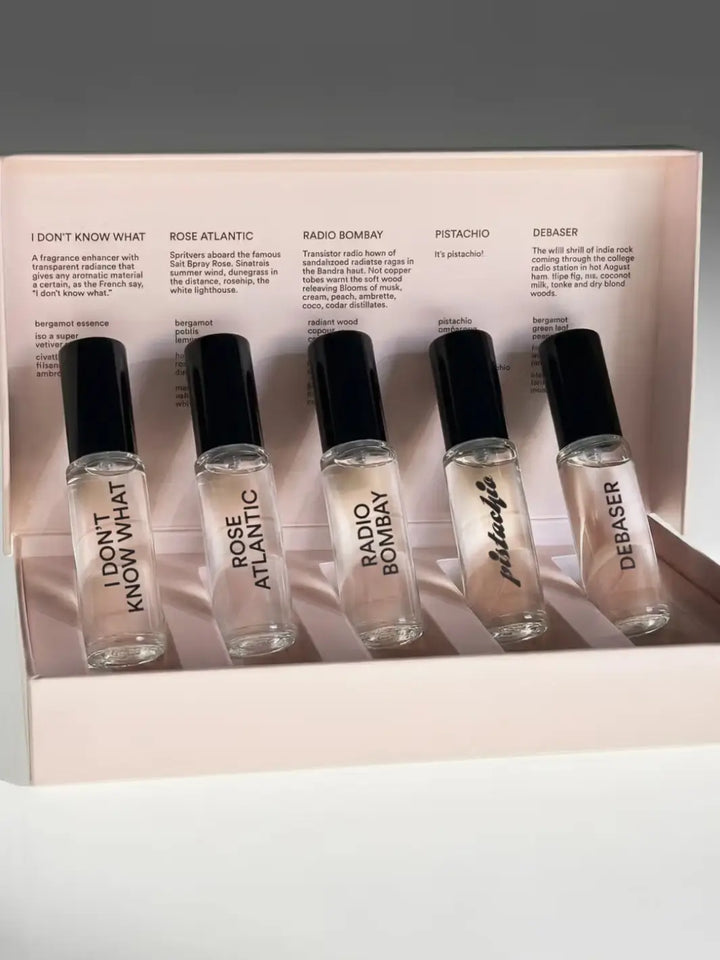 Set of five small DS&Durga 'Greatest Hits' perfume bottles in a display case with labels and descriptions | Twentyseven Toronto