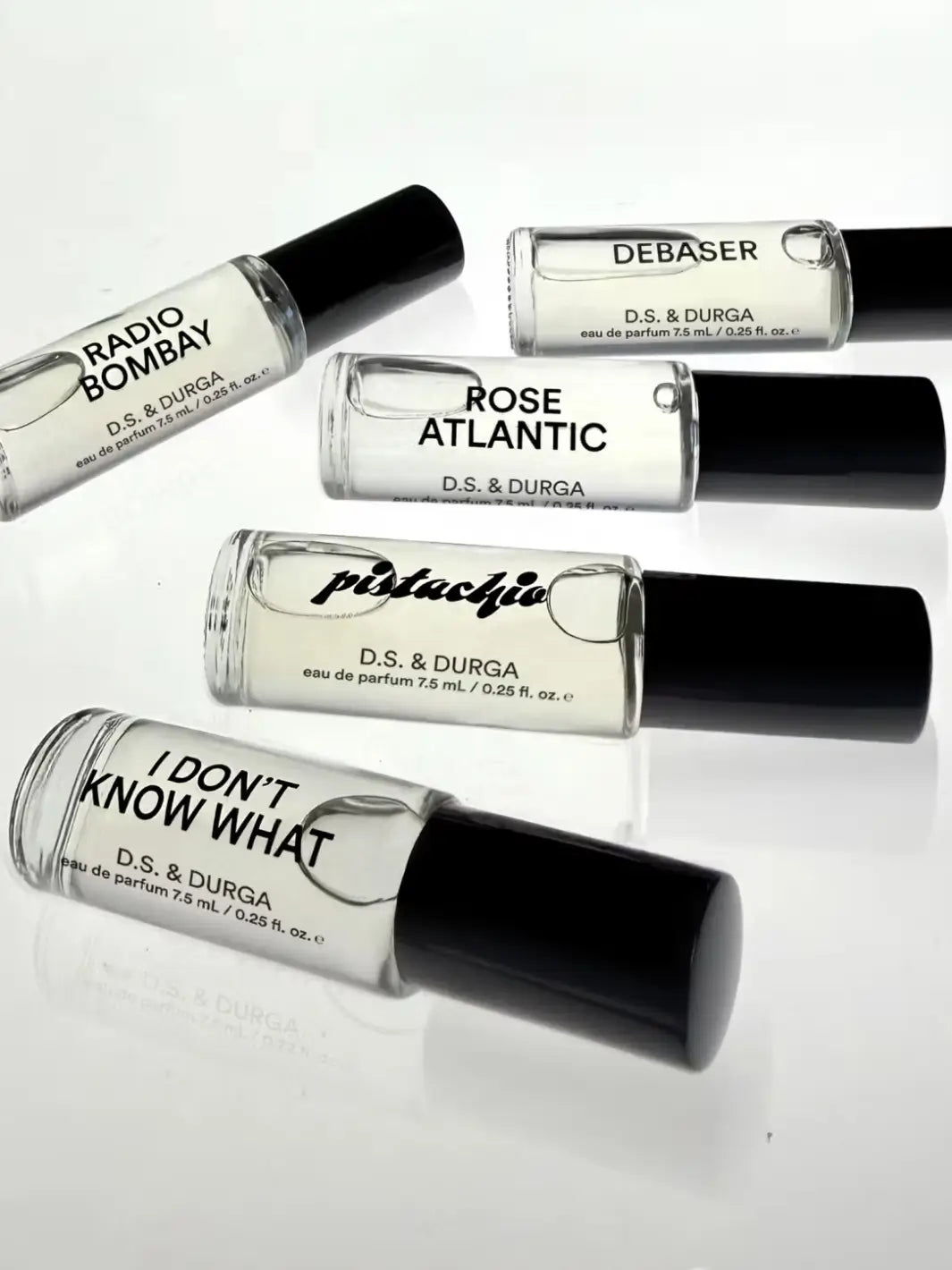 Collection of D.S. & Durga perfume bottles with in 'Radio Bombay', 'Debaser', 'Rose Atlantic', 'Pistachio', and 'I Don't Know What' on a white background | Twentyseven Toronto