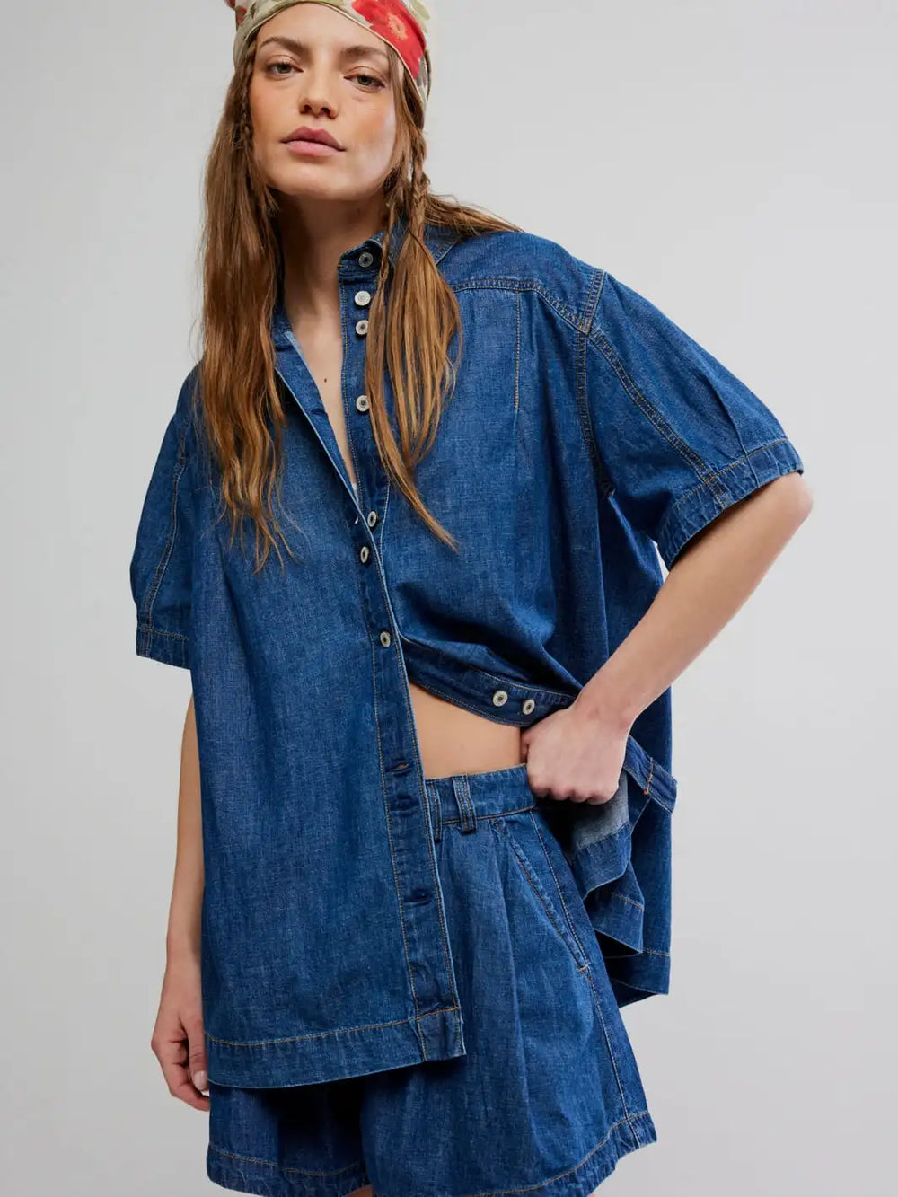 Woman wearing the Free People Griselda Set in Sea Dream Wash, a blue denim outfit on a plain white background | Twentyseven Toronto