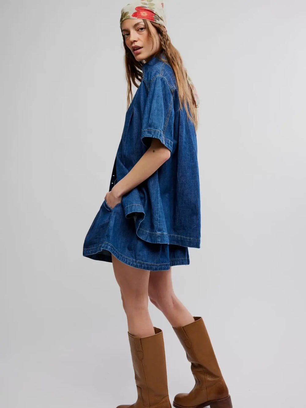 Woman wearing a blue denim set from Free People in Griselda Set 'Sea Dream Wash' and brown boots on a white background | Twentyseven Toronto