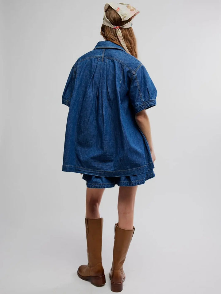 Woman wearing a blue denim set from Free People in Griselda Set 'Sea Dream Wash' with brown boots on a white background | Twentyseven Toronto
