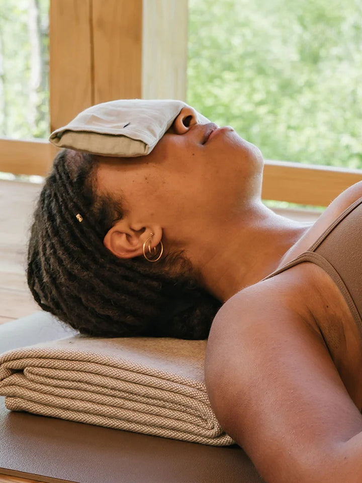 Person resting with the b, halfmoon Linen Eye Pillow placed over their eye | Twentyseven Toronto