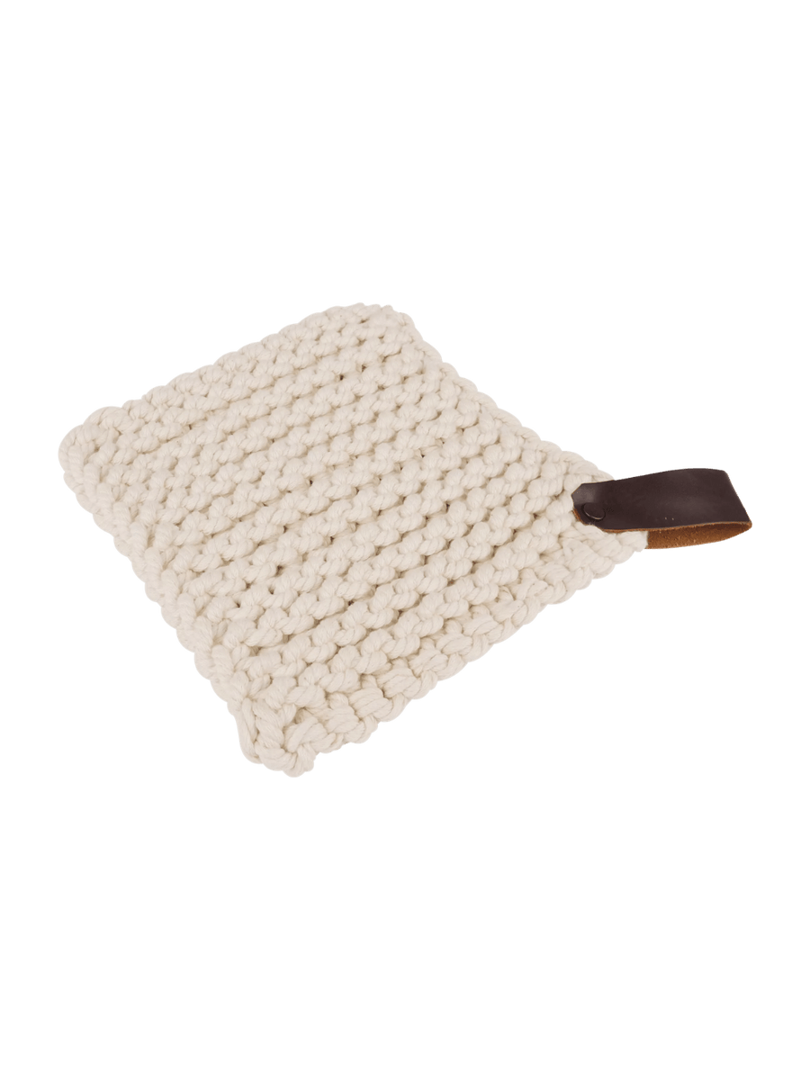 White knitted trivet with a brown leather strap from Burstenhaus Redecker on a black background | Twentyseven Toronto