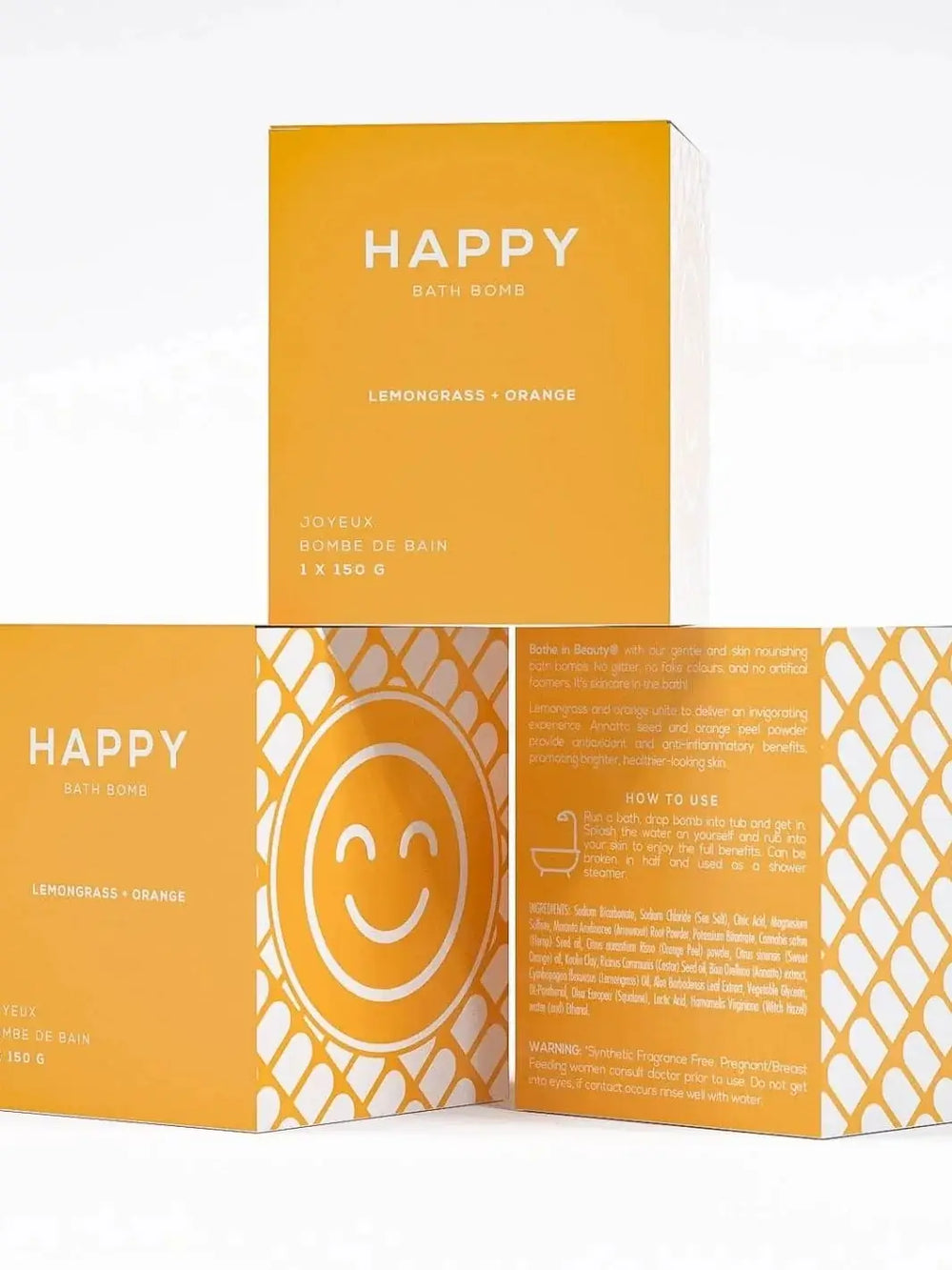Three yellow boxes for the Bare Skin Bar HAPPY Bath Bomb are stacked to display the front product label, a side panel with a smiling face graphic, and the detailed ingredients on the back | Twentyseven Toronto