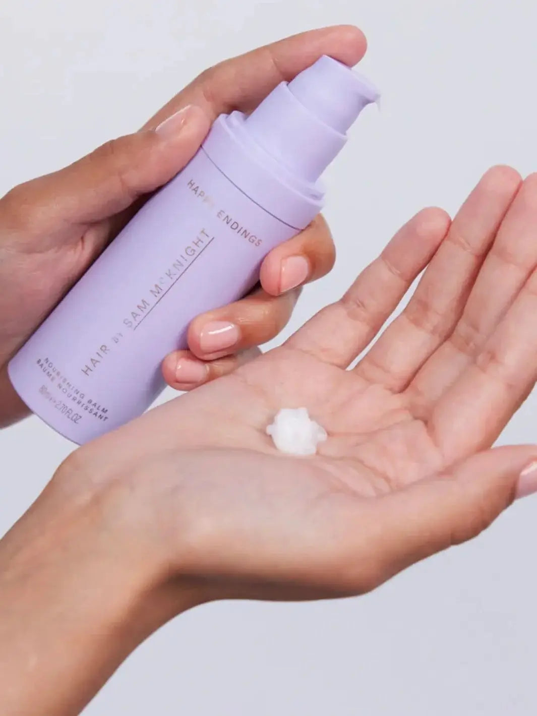 A close-up shows a white cream formula being pumped into an open hand, illustrating the texture and application of Hair by Sam McKnight Light Cleanse Hair & Scalp Shampoo | Twentyseven Toronto