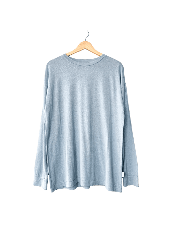 Baby blue long-sleeve 'Haze Linen Blend Tee' shirt in 'Moonbeam' from Le Bon Shoppe on a hanger against a transparent background | Twentyseven Toronto