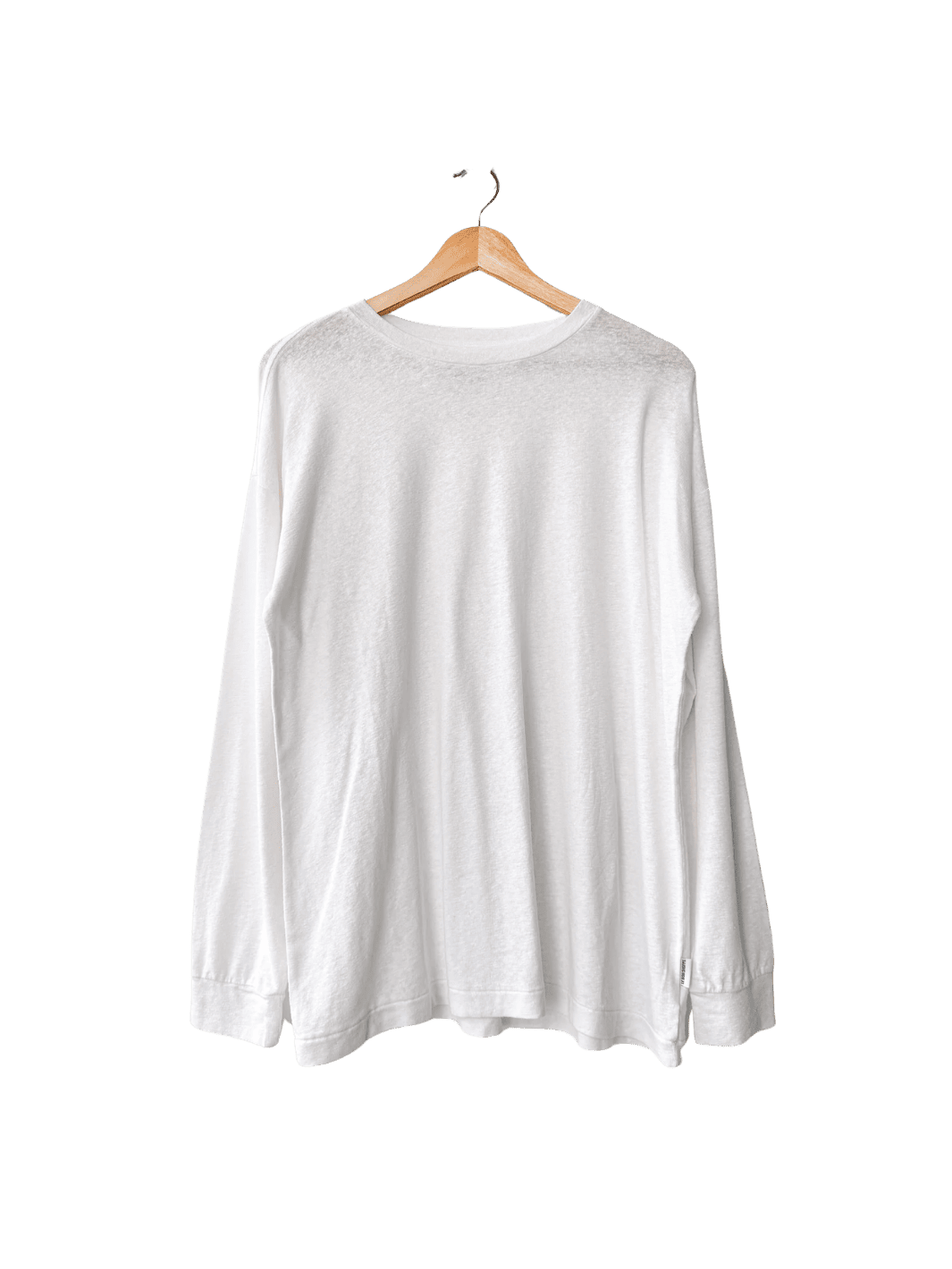 White long-sleeve 'Haze Linen Blend Tee' shirt from Le Bon Shoppe on a hanger against a transparent background | Twentyseven Toronto