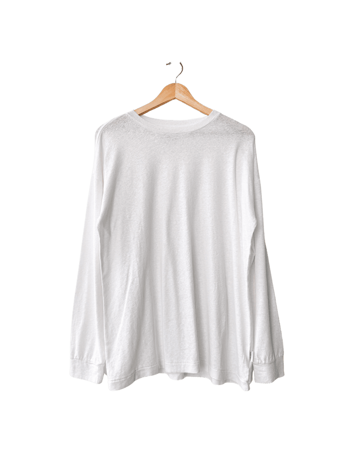 White long-sleeve 'Haze Linen Blend Tee' shirt from Le Bon Shoppe on a hanger against a transparent background | Twentyseven Toronto