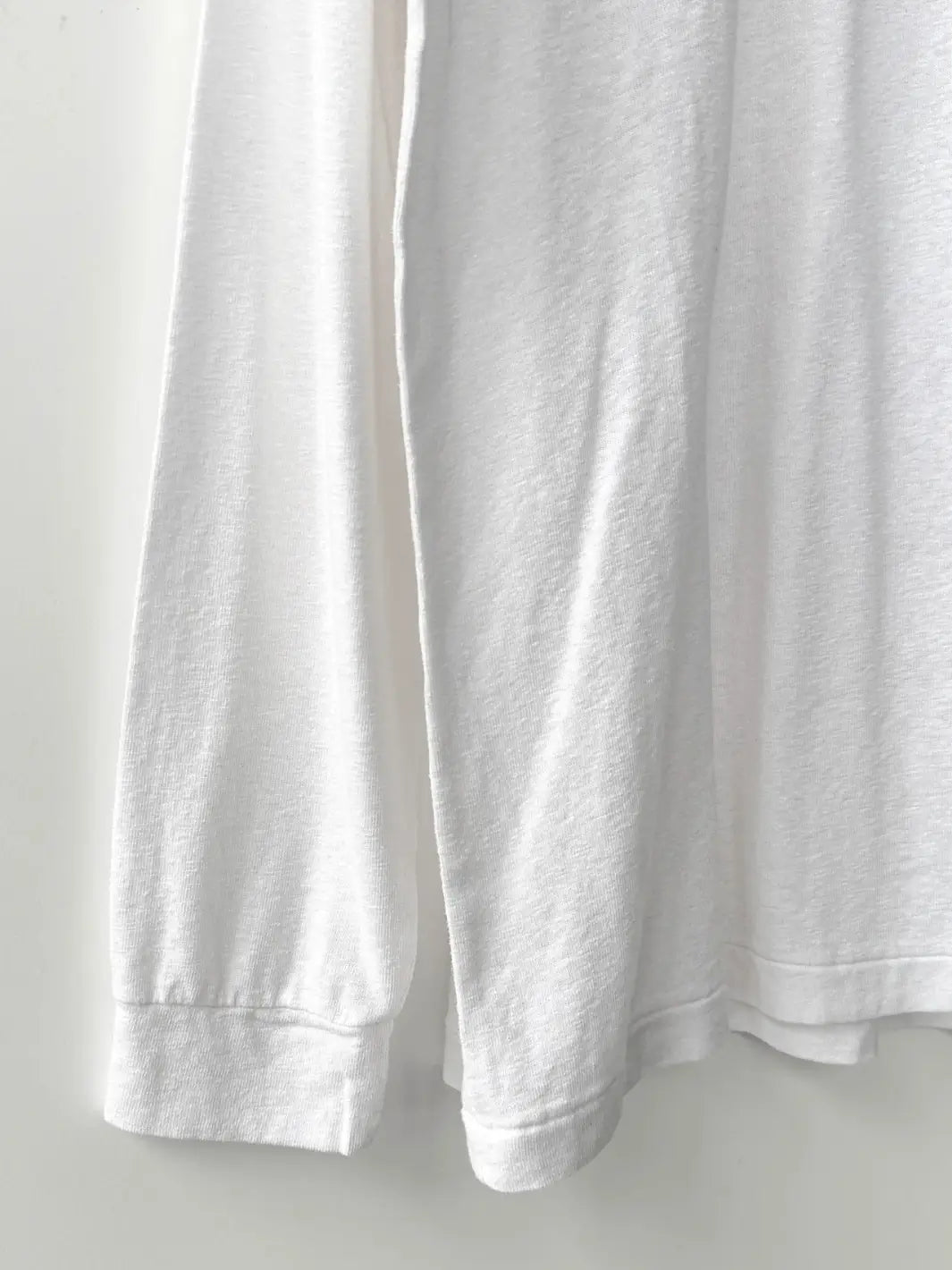 Close up of white 'Haze Linen Blend Tee' sweatshirt from Le Bon Shoppe on a light gray background | Twentyseven Toronto