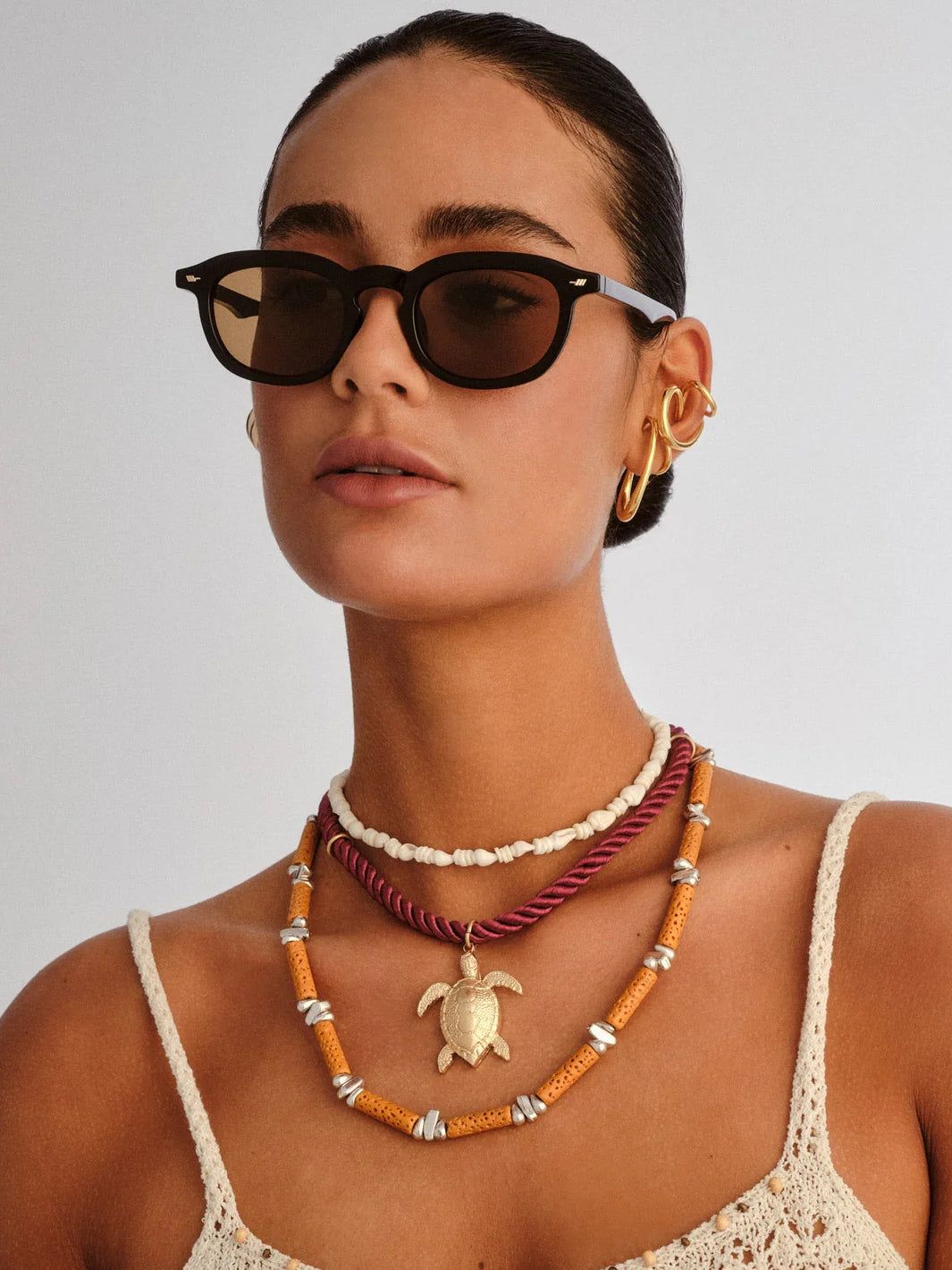 Model wearing Le Specs Heart Throb black sunglasses with rounded frames and light brown lenses | Twentyseven Toronto