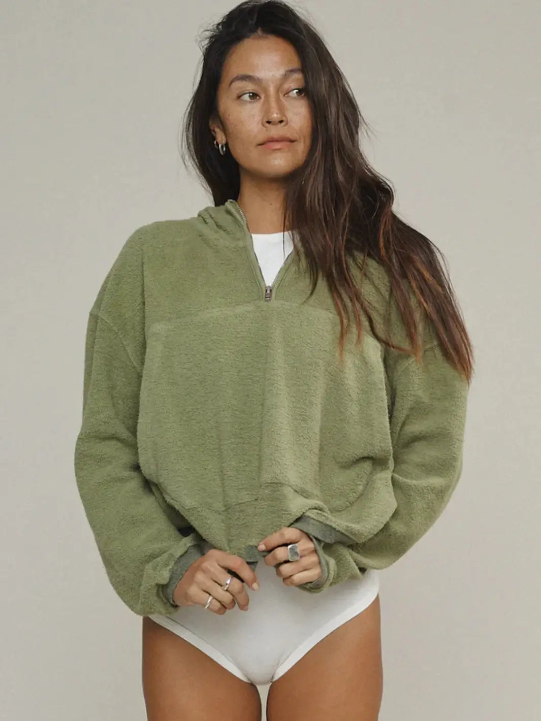 A front view of a model showcasing the half-zip collar and textured fabric of the Jungmaven Heathered Osprey Cropped Sweatshirt - Olive Green | Twentyseven Toronto